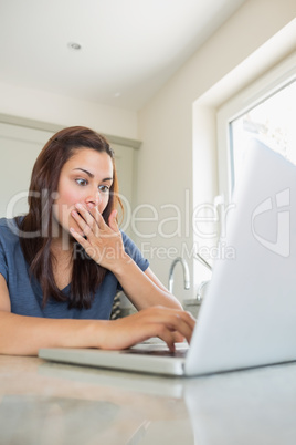 Surprised woman using the laptop