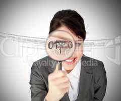 Woman looking through magnifying glass at numbers