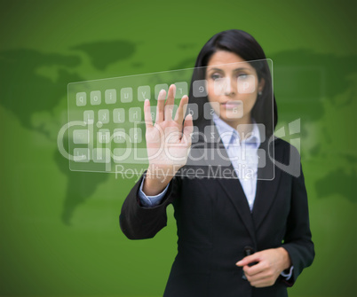 Woman touching digital keyboard against green background