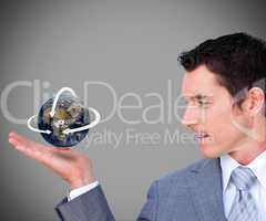 Hovering globe in businessmans hand