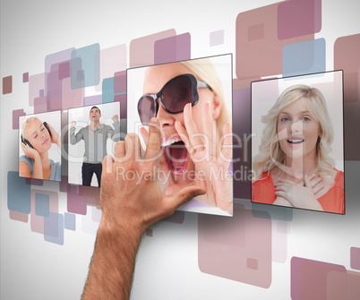 Male hand selecting photo from digital wall