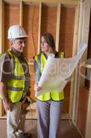 Woman and man discussing blueprints