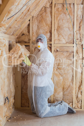 Worker filling walls with insulation