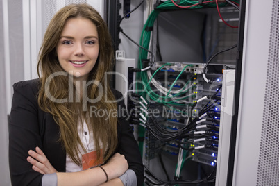 Girl standing in front of rack mounted servers