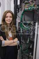 Girl standing beside rack mounted servers