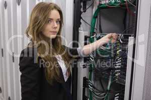 Girl working on mounted rack servers