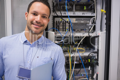 Man smiling in front of the servers