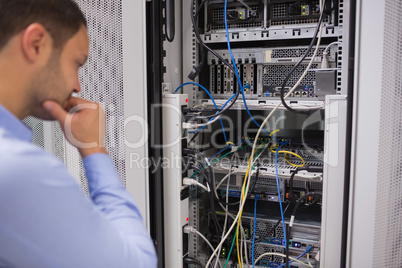 Man looking at rack mounted servers