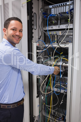 Smiling man adjusting server