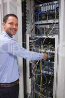 Smiling man adjusting server