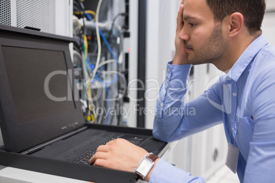 Man running diagnostics of servers