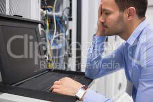 Man running diagnostics of servers