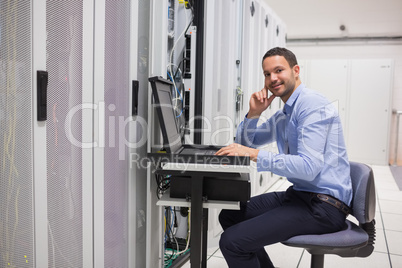 Man looking up from working with servers