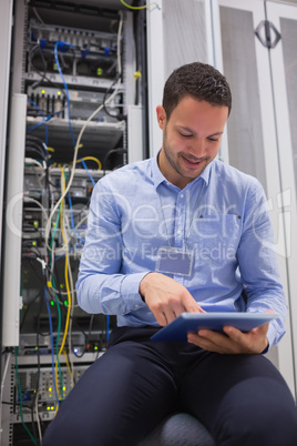 Technician using tablet pc to work on servers