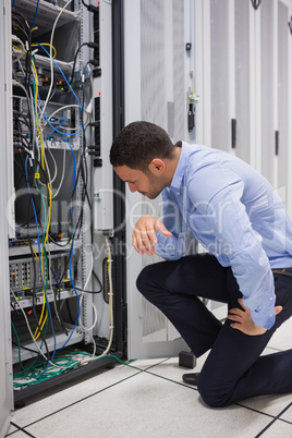 Technician looking at cables of the server