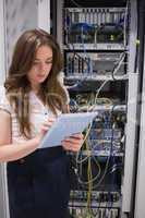 Woman checking servers using tablet pc