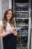 Smiling woman using tablet pc to work on servers