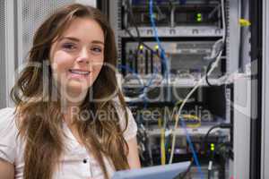 Smiling woman standing in front of servers