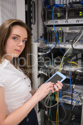 Woman checking servers with tablet pc