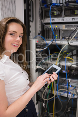 Smiling woman with tablet pc checking servers