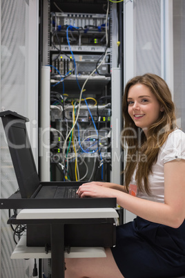 Happy woman running diagnostics on servers