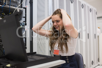 Stressed woman working on the server