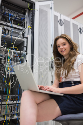 Woman with laptop doing data storage
