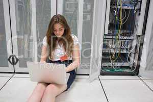 Woman working on servers sitting on the floor