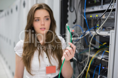 Woman holding wire at the servers