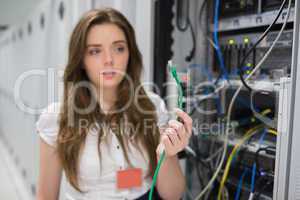 Woman holding wire at the servers