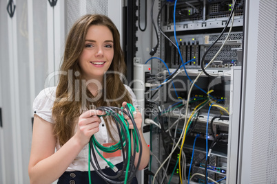 Happy woman holding server wires