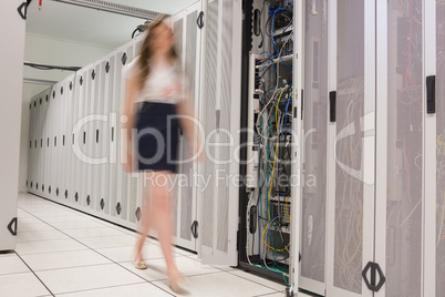 Woman walking through data center
