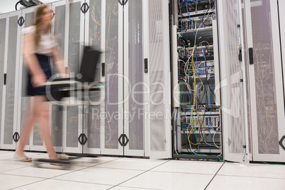 Woman pushing computer through data center