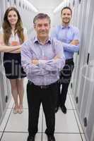 Smiling technicians standing in data center