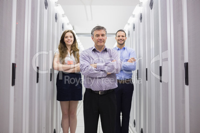 Three smiling technicians standing in data center