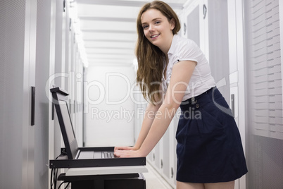 Female technician doing maintenance on servers