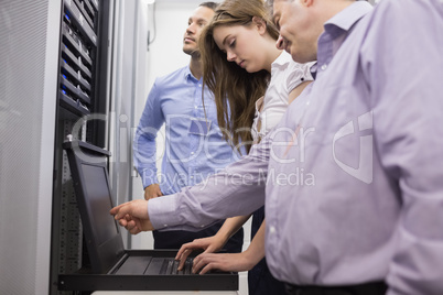 Technicians checking servers with laptop