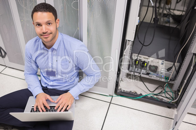 Man smiling while doing server maintenance