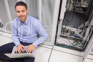 Man smiling while doing server maintenance