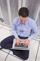 Man using his laptop in data center