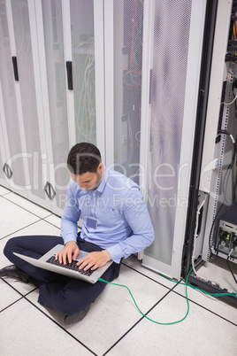 Technician connecting laptop to servers
