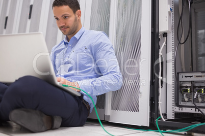 Man concentrating on laptop connected to server