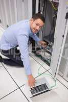 Smiling technician inserting a USB