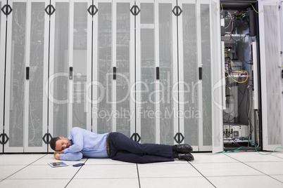 Man sleeping in front of servers