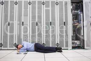 Man sleeping in front of servers