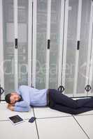 Technician sleeping in front of servers