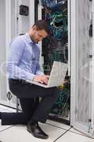 Concentrated technician doing data storage
