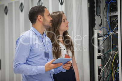 Two technicians doing maintenance with tablet pc