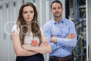 Man and woman standing in data center