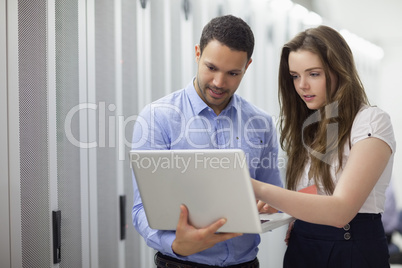 Two technicians looking at laptop